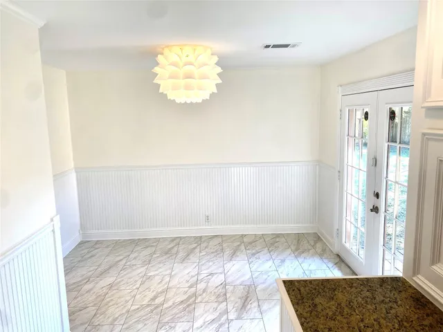 a view of a room with wooden floor and a window