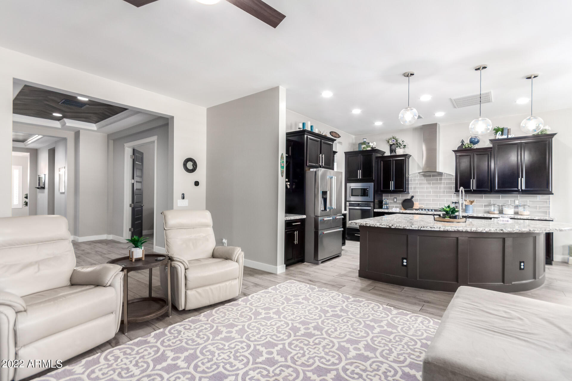 28001 92nd Avenue Peoria, AZ 85383 - Photo 11 of 45 a living room with furniture and kitchen view