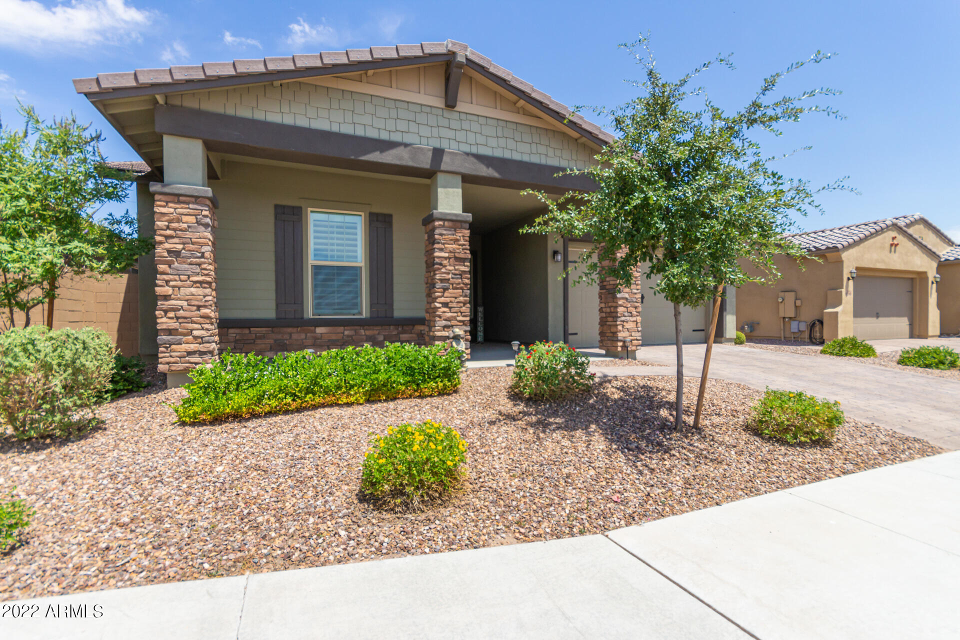 28001 92nd Avenue Peoria, AZ 85383 - Photo 2 of 45 a front view of a house with garden