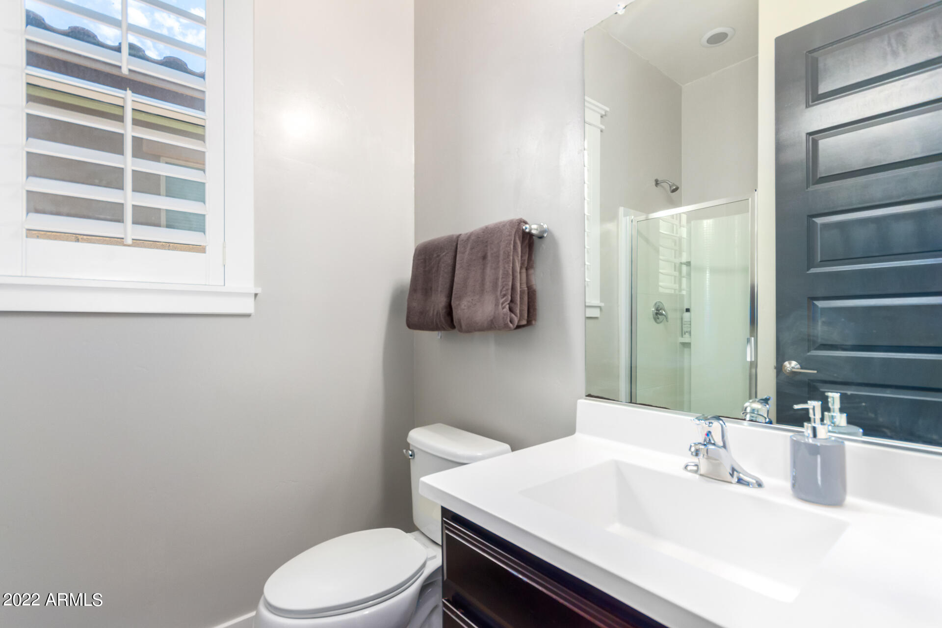 28001 92nd Avenue Peoria, AZ 85383 - Photo 29 of 45 a bathroom with a sink a toilet and mirror