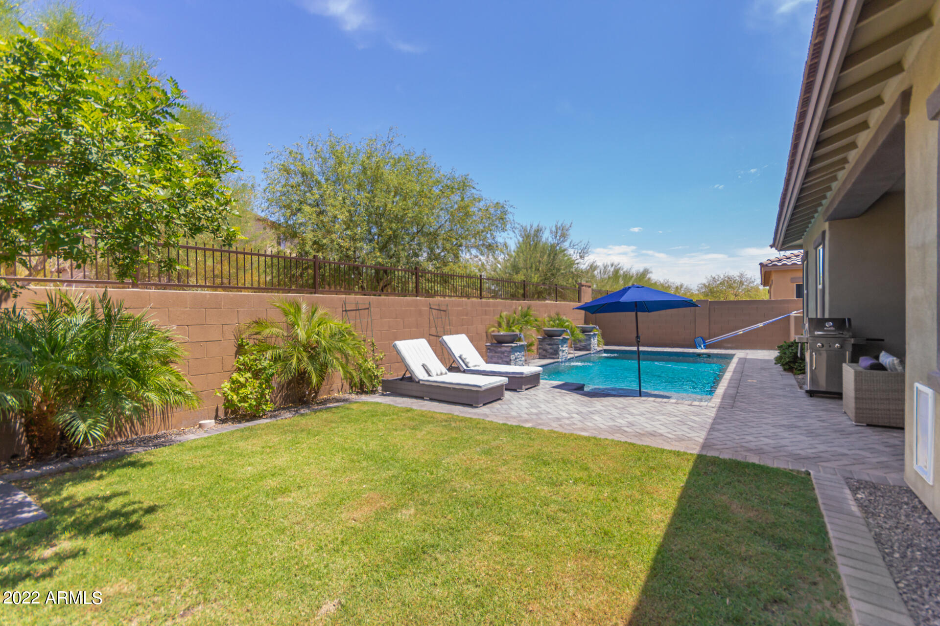 28001 92nd Avenue Peoria, AZ 85383 - Photo 40 of 45 a view of a swimming pool with a patio and a yard