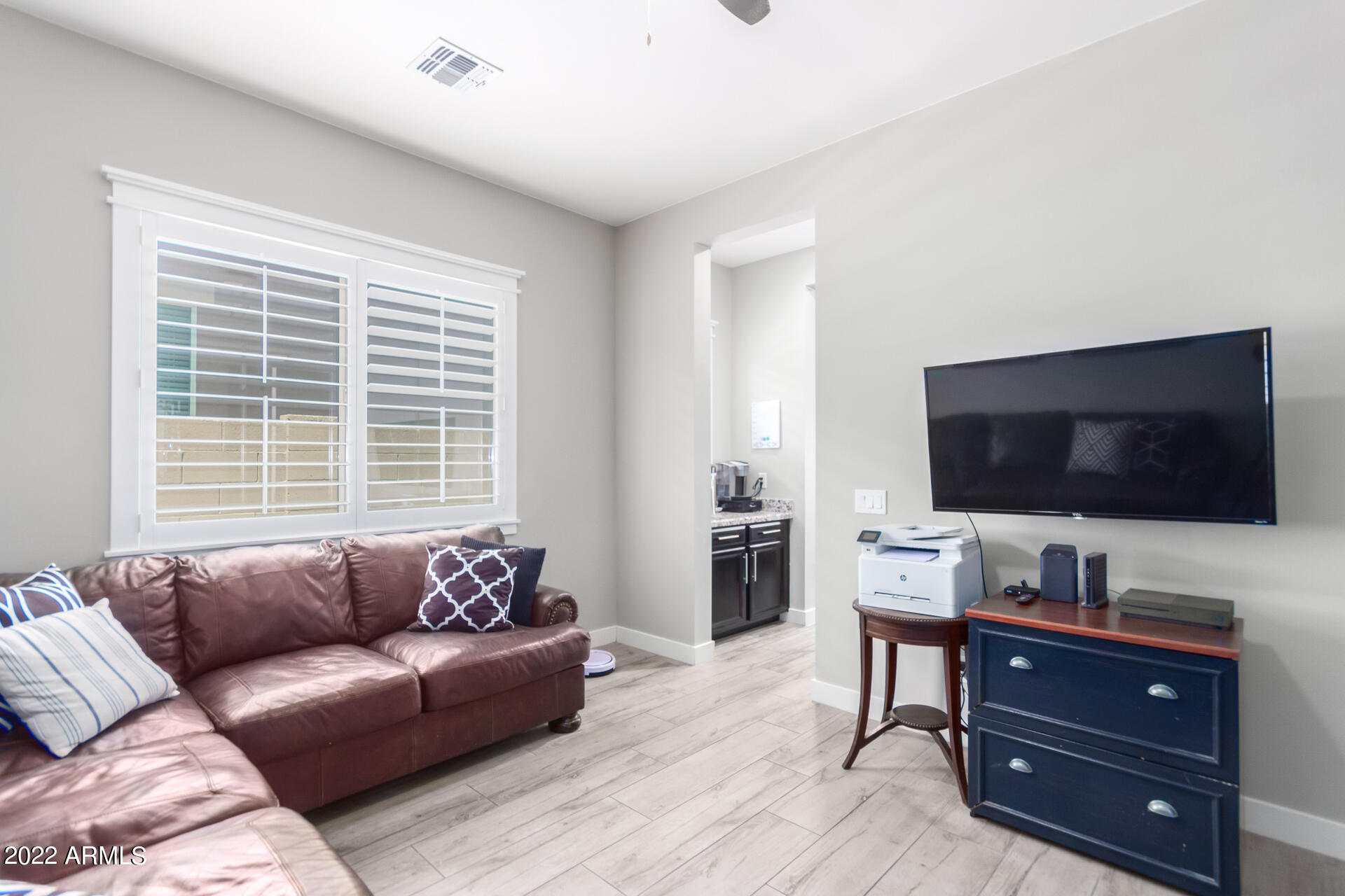 28001 92nd Avenue Peoria, AZ 85383 - Photo 7 of 45 a living room with furniture and a flat screen tv