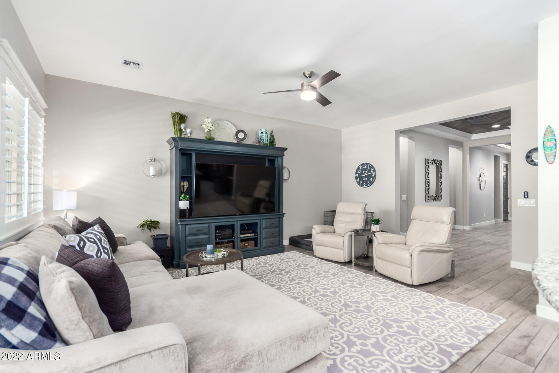 28001 92nd Avenue Peoria, AZ 85383 - Photo 8 of 45 a living room with furniture and a flat screen tv