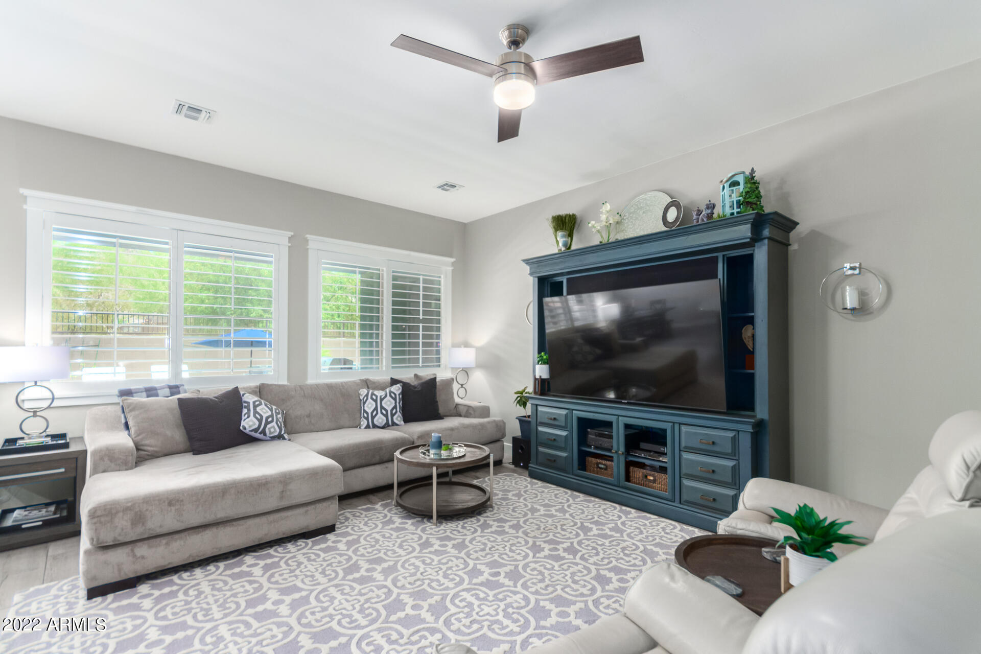 28001 92nd Avenue Peoria, AZ 85383 - Photo 9 of 45 a living room with furniture and a flat screen tv