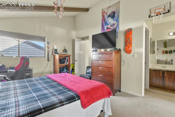 a bed room with a bed and a flat screen tv