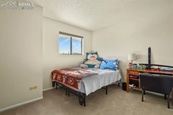 a bedroom with a bed and a table in it