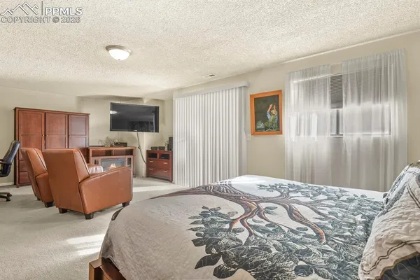 a bedroom with furniture and wooden floor