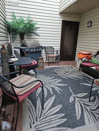 a backyard of a house with barbeque oven table and chairs