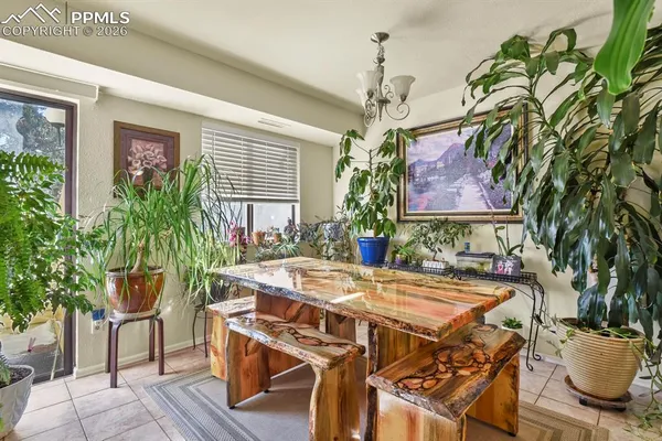 a view of a dining room with furniture and chandelier