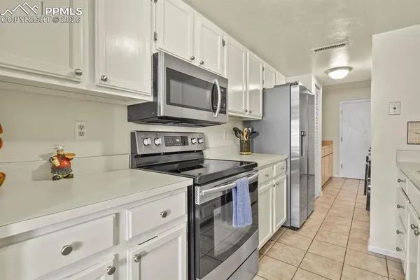 a kitchen with stainless steel appliances a stove a microwave and cabinets