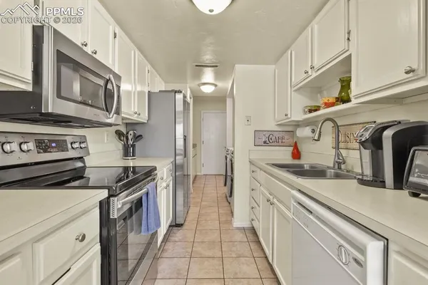 a kitchen with stainless steel appliances granite countertop a sink and cabinets