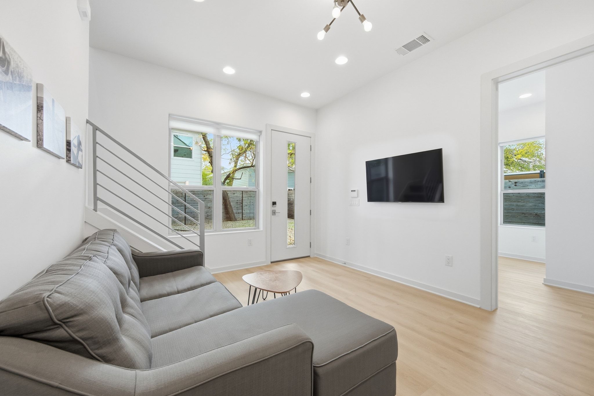 2811 Garwood Street, Unit B Austin, TX 78702 - Photo 8 of 24 Living area featuring light wood-style flooring, healthy amount of natural light, recessed lighting, and stairs