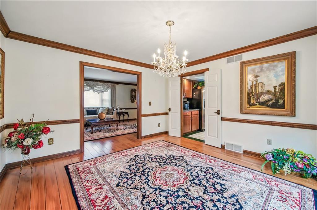 689 Tanglewood Road Hermitage, PA 16148 - Photo 11 of 42 a living room with furniture and a chandelier