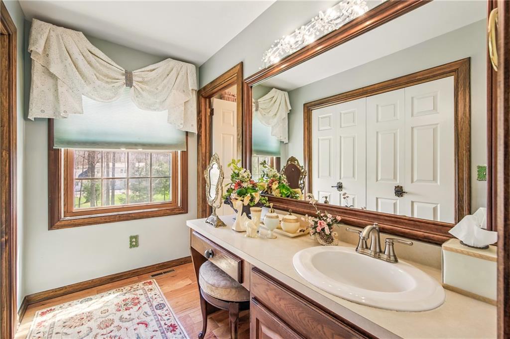689 Tanglewood Road Hermitage, PA 16148 - Photo 23 of 42 a bathroom with a granite countertop sink and a mirror