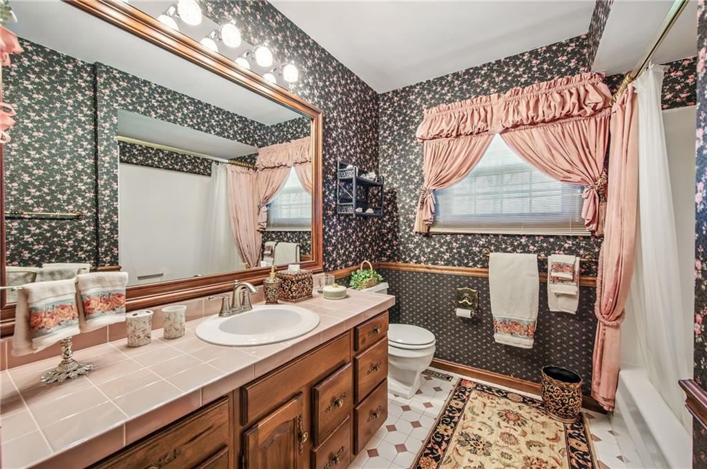 689 Tanglewood Road Hermitage, PA 16148 - Photo 31 of 42 a bathroom with a granite countertop sink mirror vanity and toilet