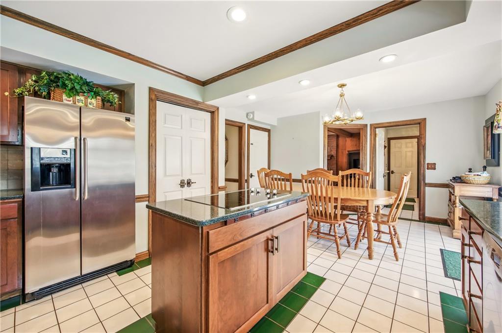 689 Tanglewood Road Hermitage, PA 16148 - Photo 8 of 42 a kitchen with stainless steel appliances granite countertop a refrigerator a sink a stove and white cabinets