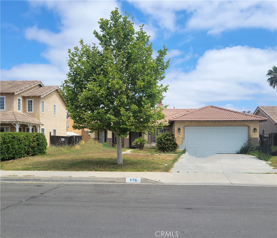 658 Primrose Place Perris, CA 92571 - Photo 1 of 1 a front view of a house with a yard and garage