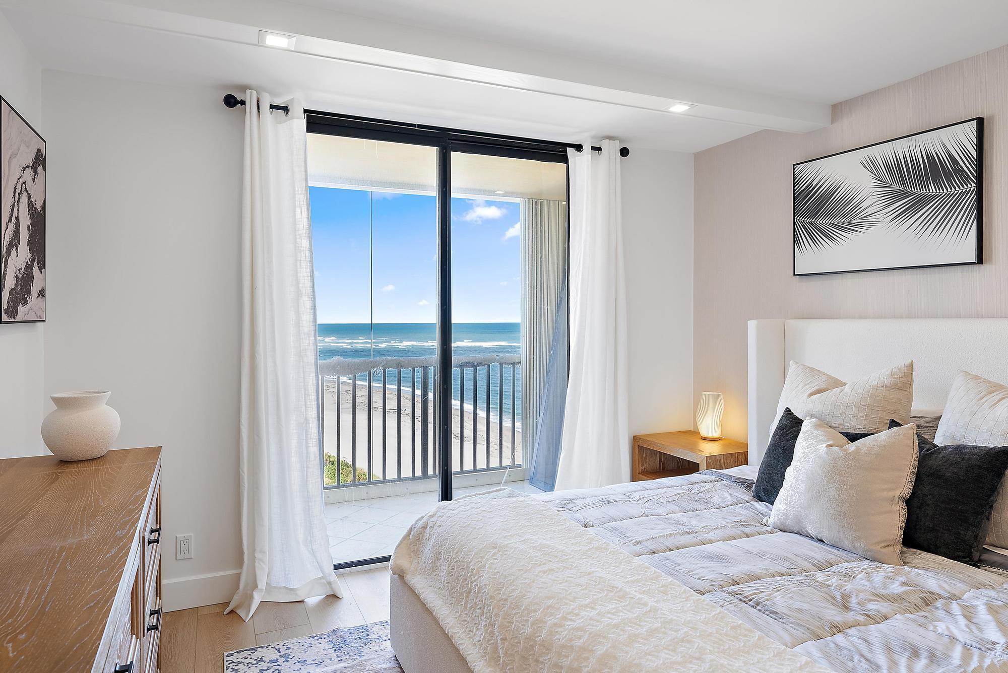 300 Ocean Trail Way, Unit 1202 Jupiter, FL 33477 - Photo 13 of 23 a bedroom with a large bed and a window