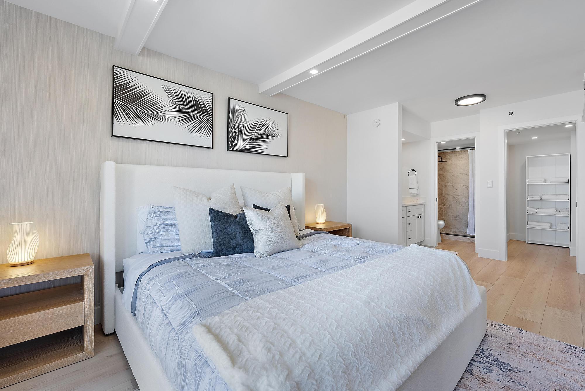 300 Ocean Trail Way, Unit 1202 Jupiter, FL 33477 - Photo 14 of 23 a bedroom with a bed and a painting on the wall