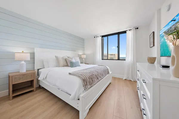 a bedroom with a bed and a dresser