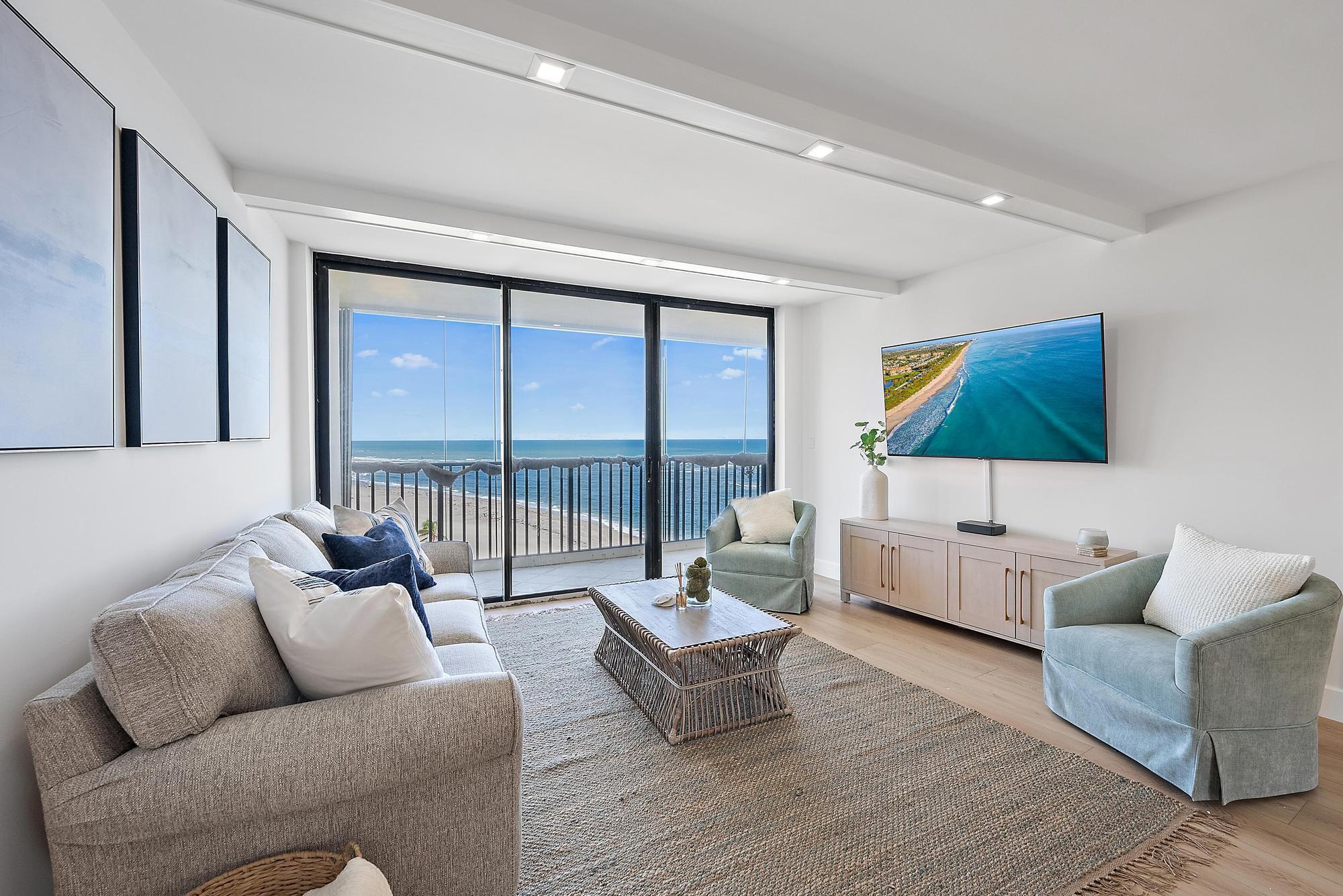 300 Ocean Trail Way, Unit 1202 Jupiter, FL 33477 - Photo 4 of 23 a living room with furniture and a flat screen tv