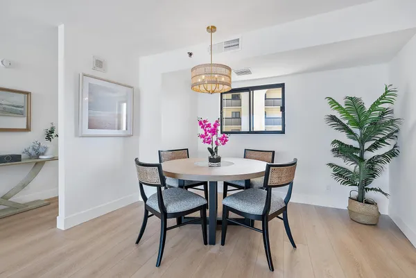 a view of a dining room with furniture wooden floor and chandelier