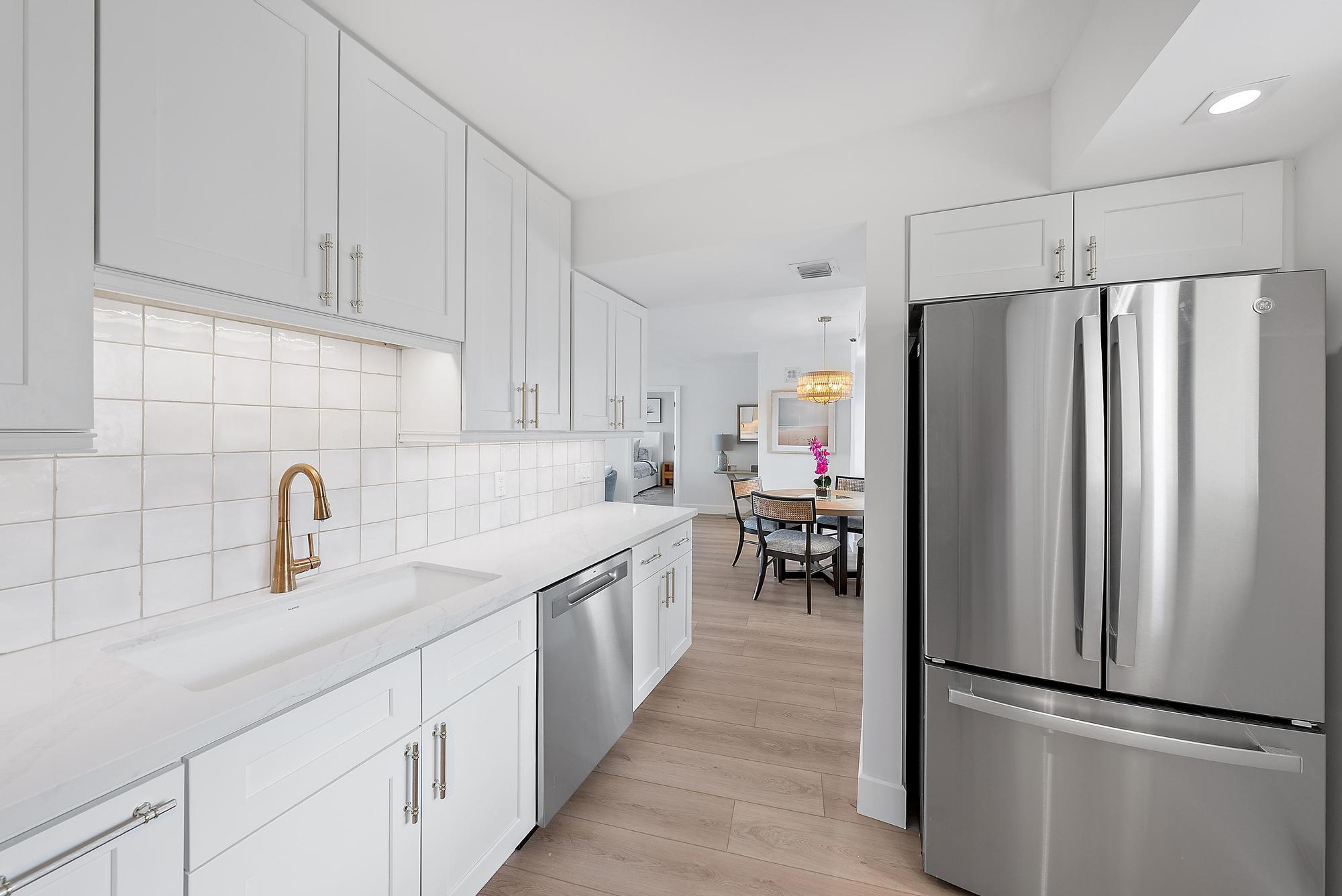 300 Ocean Trail Way, Unit 1202 Jupiter, FL 33477 - Photo 9 of 23 a kitchen with stainless steel appliances a refrigerator and a sink