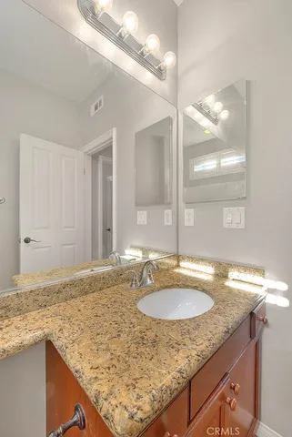 a view of a hallway with a window and stainless steel appliances