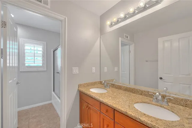 an view of an empty room with window and wooden floor