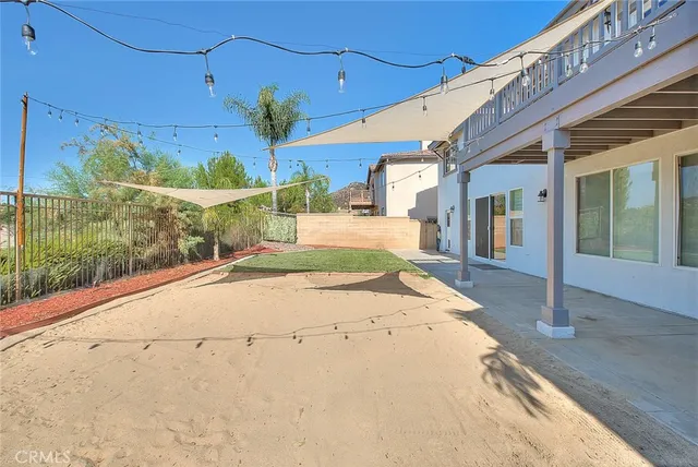 a view of a balcony with wooden floor and fence
