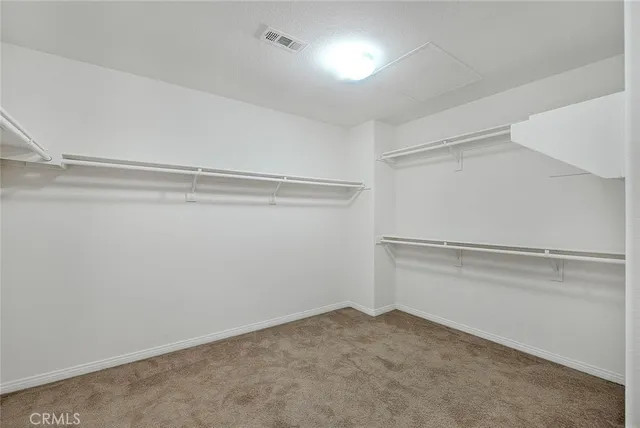 a kitchen with kitchen island granite countertop a sink and a stove top oven with wooden cabinets