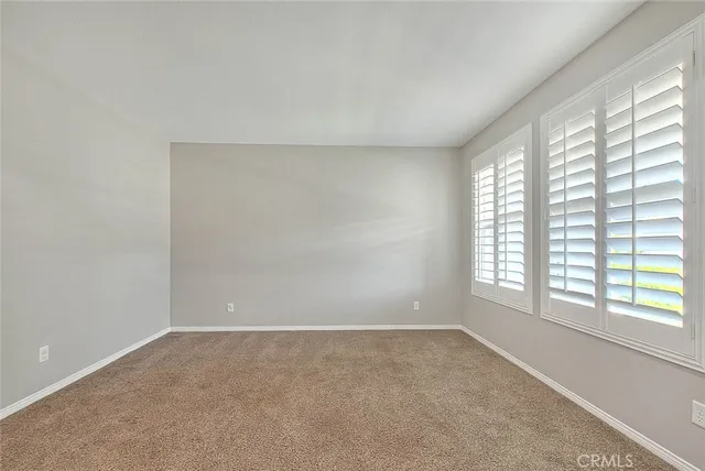 a bathroom with a granite countertop sink a toilet a mirror and bathtub