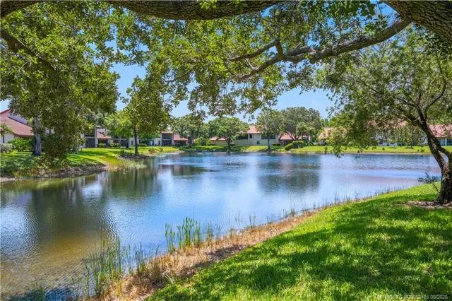 a view of a lake with houses in the back