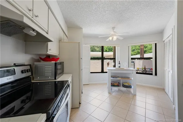 a kitchen with a sink cabinets and window
