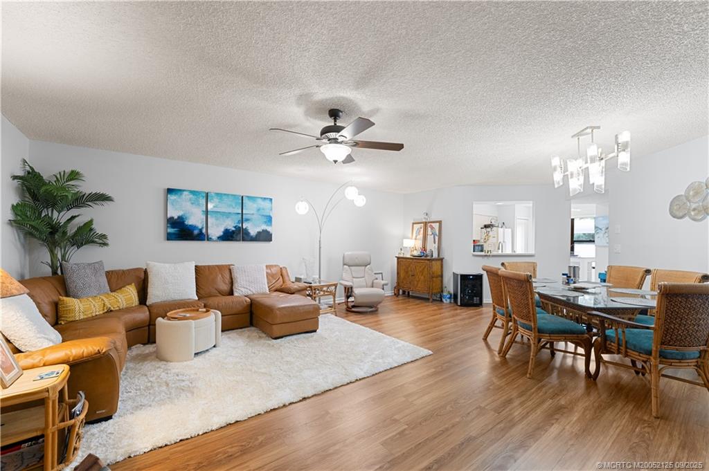 Undisclosed Address Stuart, FL 34997 - Photo 20 of 51 a living room with furniture kitchen view and a chandelier