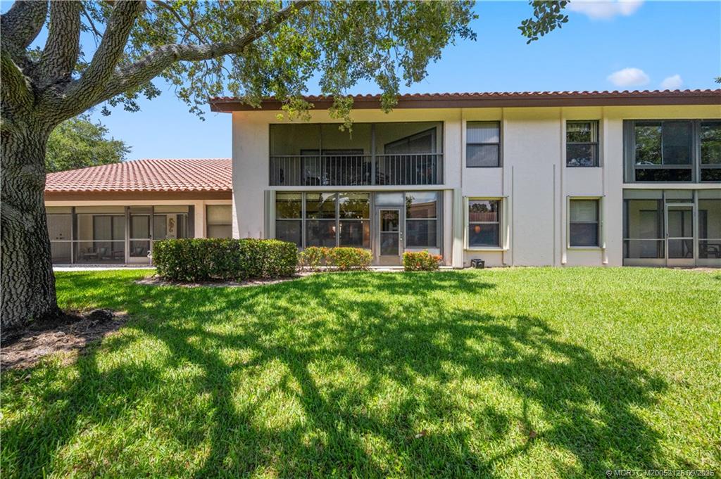 Undisclosed Address Stuart, FL 34997 - Photo 2 of 51 a view of a brick house with a large windows and a large tree
