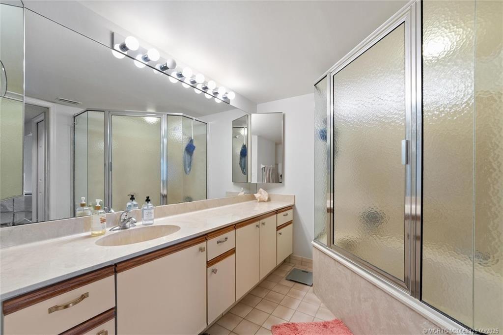 Undisclosed Address Stuart, FL 34997 - Photo 23 of 51 a bathroom with a double vanity sink mirror and shower