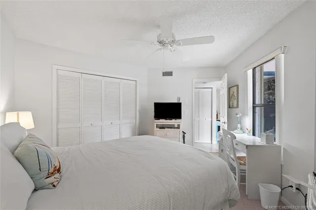 a bedroom with a bed and a flat tv screen