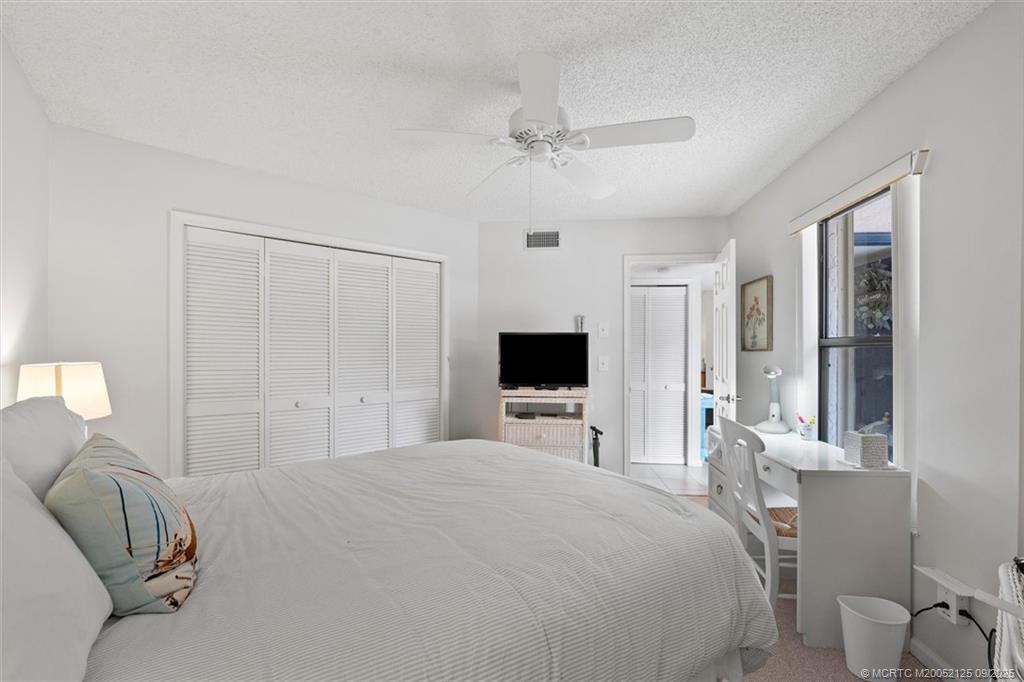 Undisclosed Address Stuart, FL 34997 - Photo 25 of 51 a bedroom with a bed and a flat tv screen