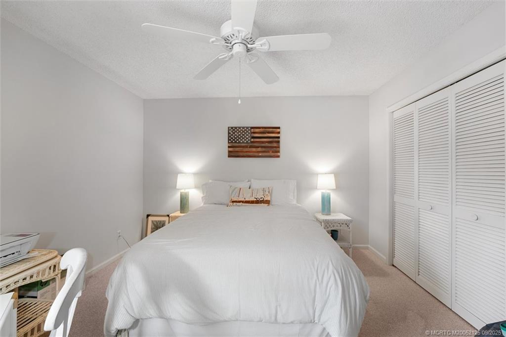 Undisclosed Address Stuart, FL 34997 - Photo 26 of 51 a bedroom with a bed and a lamp