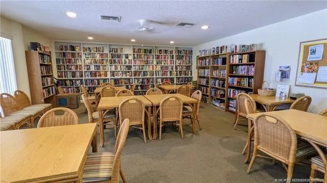 a living room with lots of furniture and a book shelf
