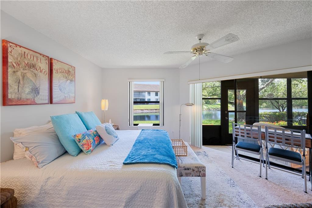 Undisclosed Address Stuart, FL 34997 - Photo 4 of 51 a bedroom with a large bed couch and a window