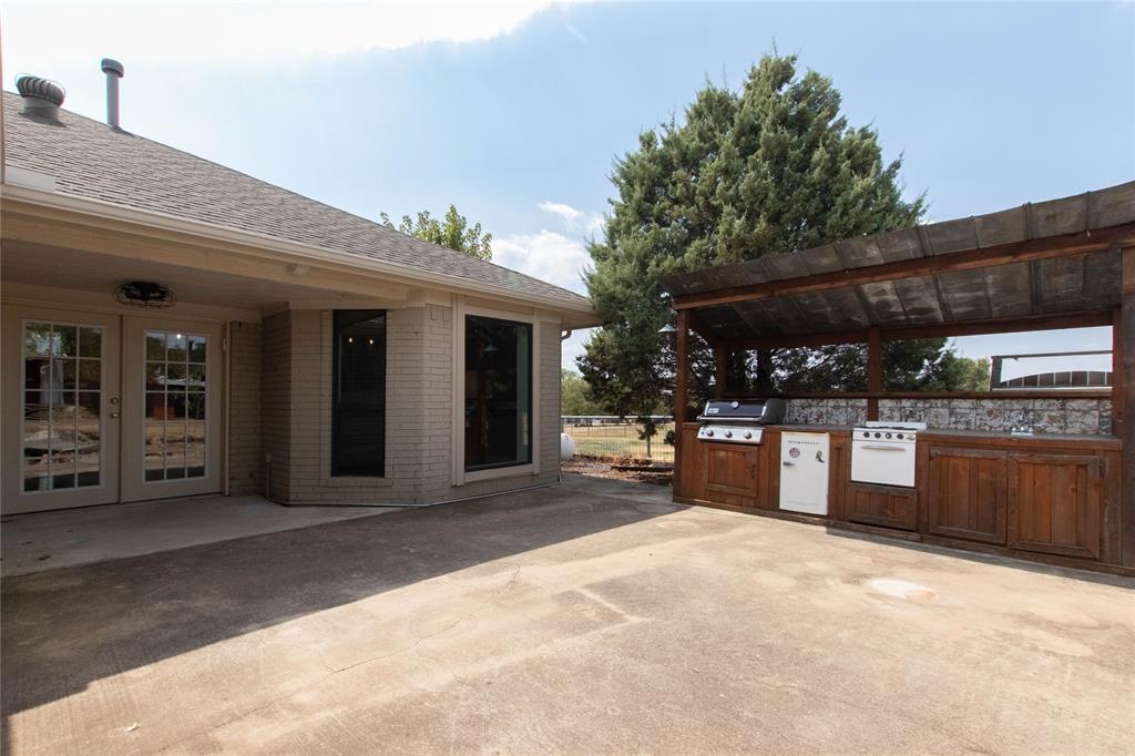 308 Sanders Road Denton, TX 76210 - Photo 28 of 31 Outdoor kitchen with built-in grill, stove, and sink