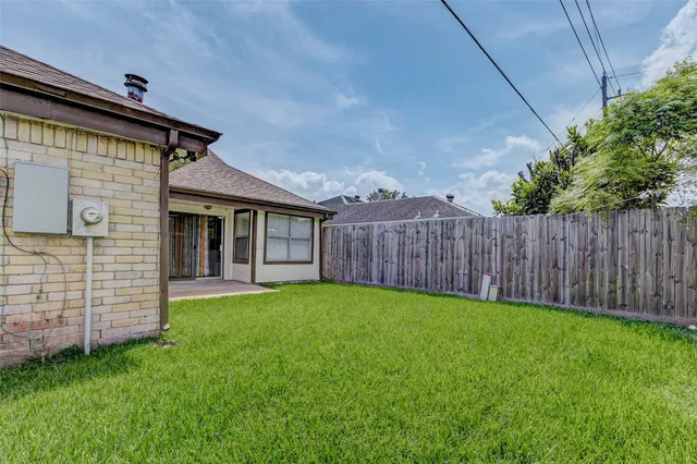 a view of a backyard with wooden fence and a stairs
