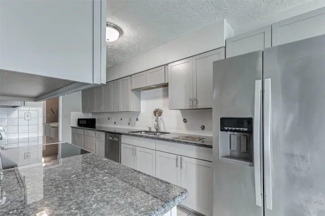 a kitchen with a sink stainless steel appliances and cabinets