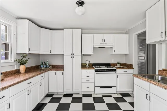 a kitchen with stainless steel appliances a stove a sink and a refrigerator