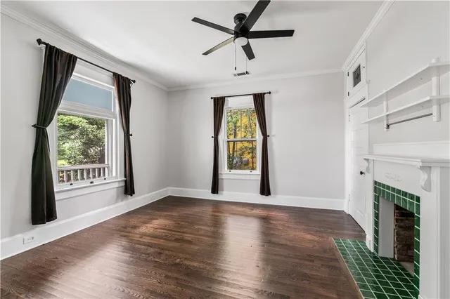 a view of an empty room with a fireplace and a window