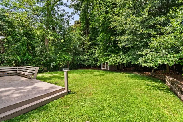 a view of a backyard with wooden fence