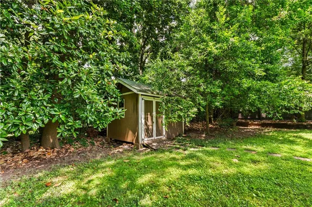 a backyard of a house with table and chairs