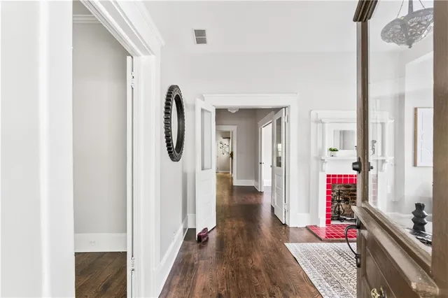a view of a hallway with wooden floor and staircase